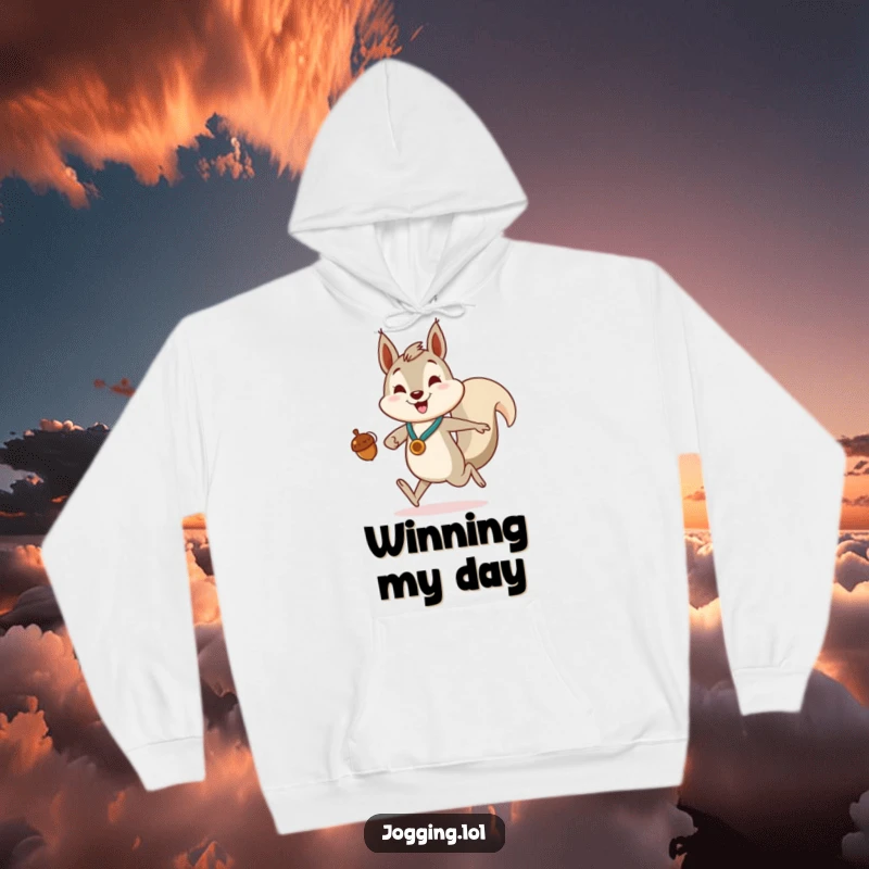 Funny Hoodie featuring a smiling squirrel character jogging with gusto, clutching an acorn like a triumphant medal.